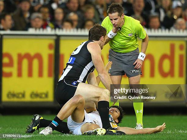 Heath Shaw of the Magpies gives away a free kick to Angus Monfries of the Power during the Second AFL Elimination Final match between the Collingwood...