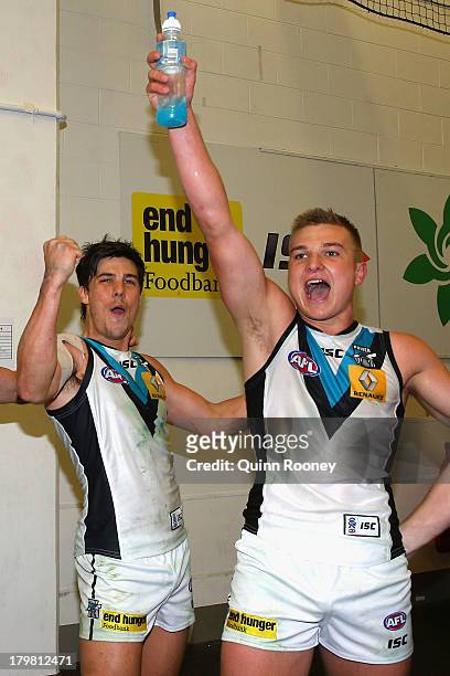 Angus Monfries and Oliver Wines of the Powersing the song in the rooms after winning the Second AFL Elimination Final match between the Collingwood...