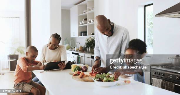 family, kitchen or cook or homework child tablet, healthy dinner or happy house. black father, daughter or prepare food vegetables ingredients for nutrition fibre diet, together and home bonding love - young family in kitchen stock pictures, royalty-free photos & images