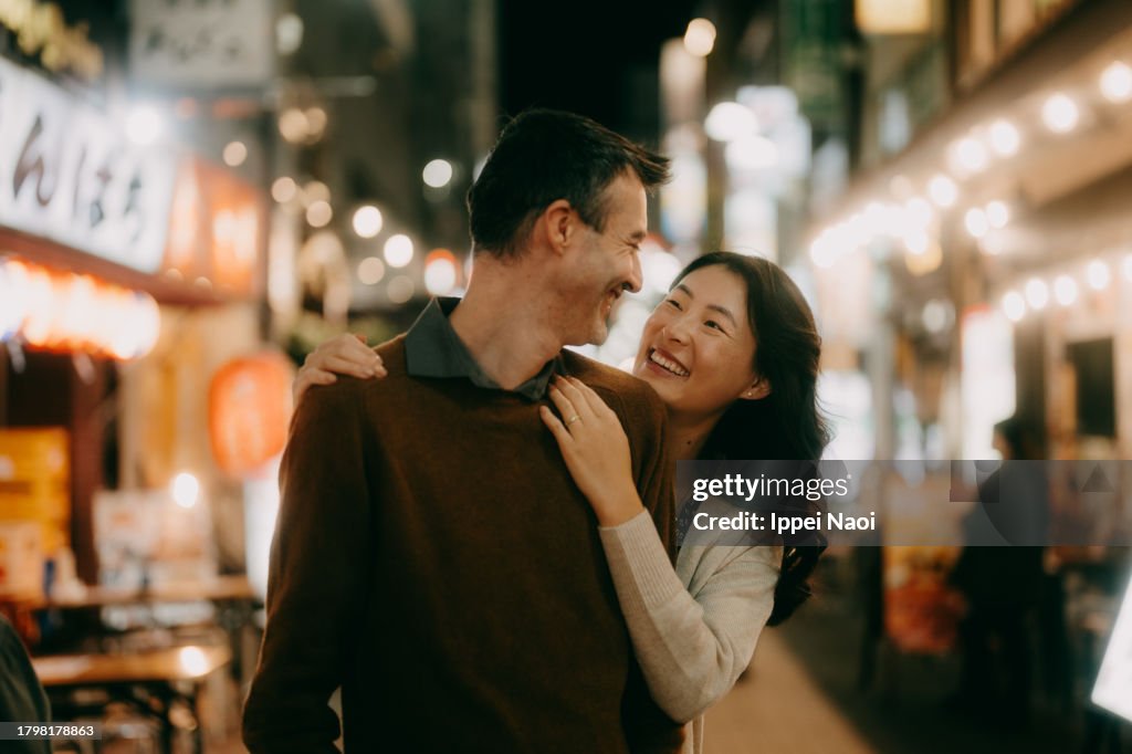 Couple having fun in Tokyo at night