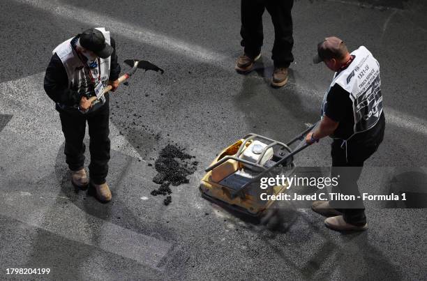 Circuit workers fix the issues with the drain covers on the track as seen from the McLaren VISTA during practice ahead of the F1 Grand Prix of Las...