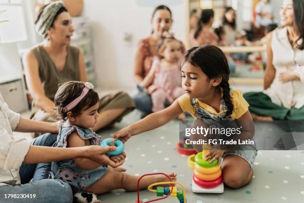 child girls playing together in the playroom - lekrum bildbanksfoton och bilder
