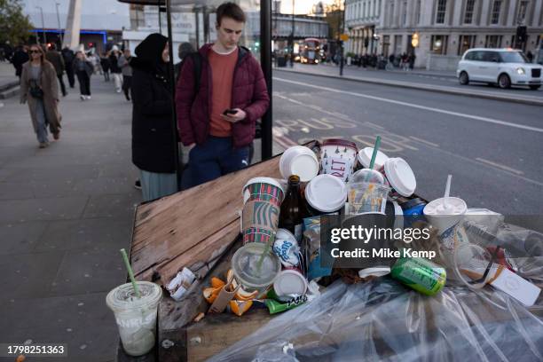 Coffee and soft drinks cups from some of the major take away food and drinks companies piled up on top of an overflowing street rubbish bin on 15th...