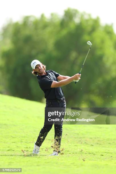 Tommy Fleetwood of England plays his second shot on the third hole during Day Two of the DP World Tour Championship on the Earth Course at Jumeirah...