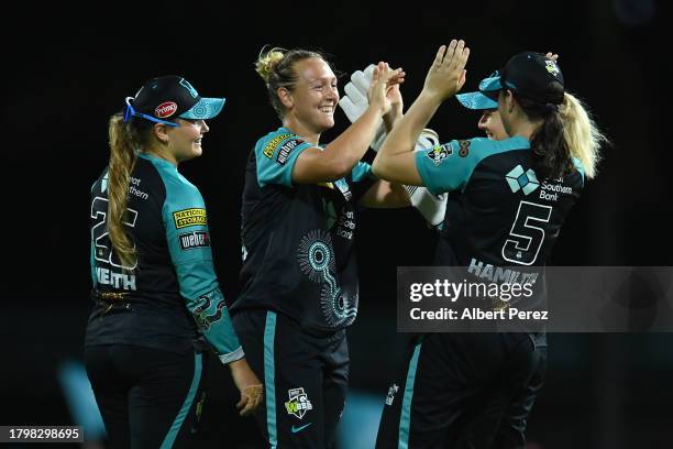 Nicola Hancock of the Heat celebrates with team mates during the WBBL match between Brisbane Heat and Melbourne Renegades at Allan Border Field, on...