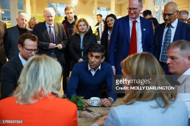 Britain's Prime Minister Rishi Sunak talks during a meeting with small business owners from Sunny Bank Mills, during a visit to The Emma White...