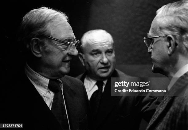 View of Nobel Prize-winning American biochemist Dr Julius Axelrod , businessman León Berlín as they speak to an unidentified man during a press...