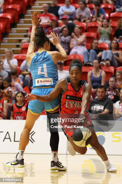 Aari McDonald of the Lynx drives to the basket against Alex Wilson of the Spirit during the WNBL match between Perth Lynx and Bendigo Spirit at...