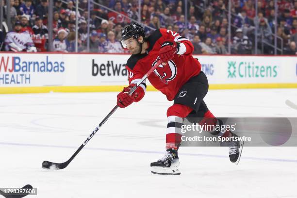 New Jersey Devils defenseman Colin Miller takes a shot during a game between the New York Rangers and New Jersey Devils on November 18, 2023 at...