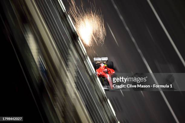 Sparks fly behind Carlos Sainz of Spain driving the Ferrari SF-23 during practice ahead of the F1 Grand Prix of Las Vegas at Las Vegas Strip Circuit...