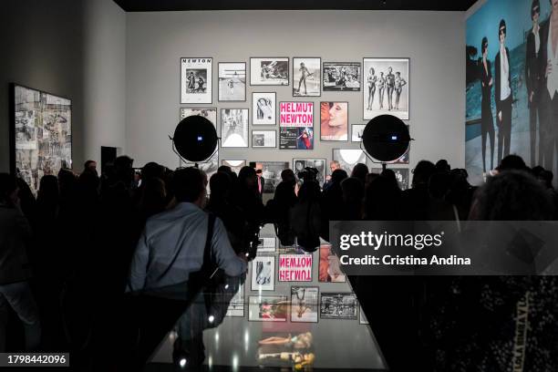 People looks at a photograph during the press conference at the opening of the exhibition Helmut Newton - Fat & Fiction at the Muelle de Batería in A...