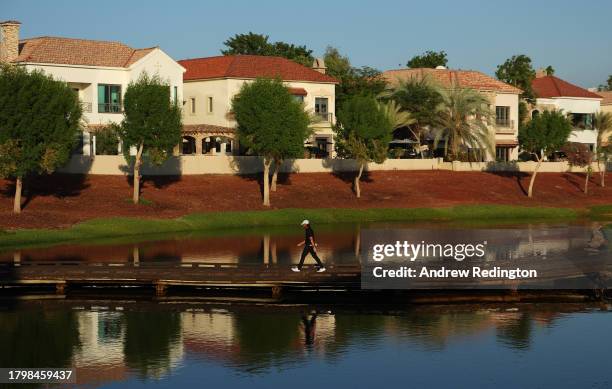 Tommy Fleetwood of England crosses a bridge on the 17th hole during Day Two of the DP World Tour Championship on the Earth Course at Jumeirah Golf...