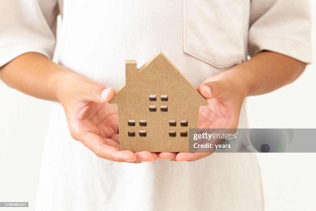 Child's hands holding household objects.