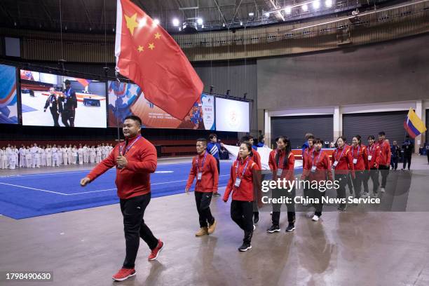 Martial arts athletes of China parade into the venue during the opening ceremony of the 16th World Wushu Championships at the gymnasium of Fort Worth...