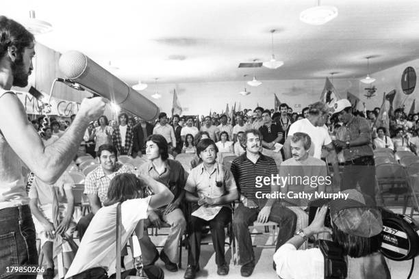 Photographers and film crew members document a United Farm Workers press conference, 1977. Pictured are labor activists Eliseo Medina , unidentified,...