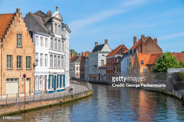 medieval architecture and the canal in bruges, belgium - bruges belgium stock pictures, royalty-free photos & images