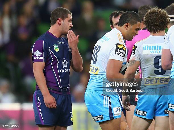 Kenneath Bromwich of the Storm looks on after tackling Mark Ioane of the Titans during the round 26 NRL match between the Melbourne Storm and the...