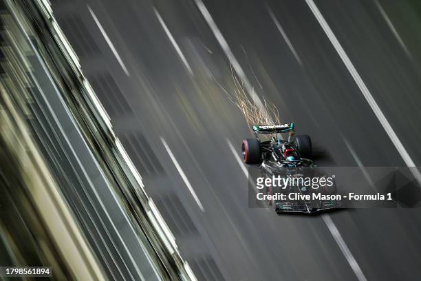Sparks fly behind the car of George Russell of Great Britain driving the Mercedes AMG Petronas F1 Team W14 on track during practice ahead of the F1...