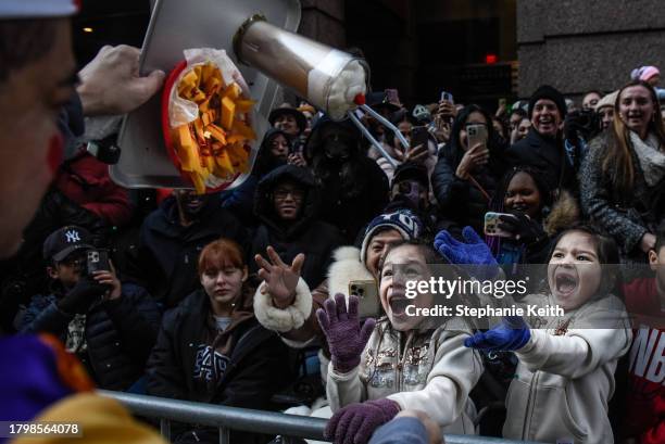 Spectators watch the Macy's annual Thanksgiving Day Parade on November 23, 2023 in New York City. Thousands of people lined the streets to watch the...