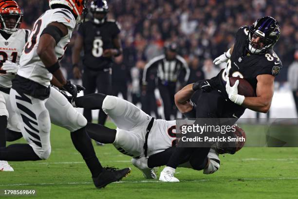 Mark Andrews of the Baltimore Ravens is tackled by Logan Wilson of the Cincinnati Bengals during the first quarter of the game at M&T Bank Stadium on...