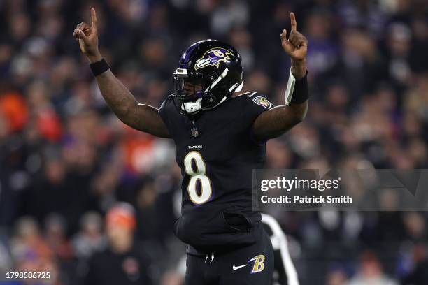 Lamar Jackson of the Baltimore Ravens celebrates a touchdown scored by Gus Edwards against the Cincinnati Bengals during the fourth quarter of the...