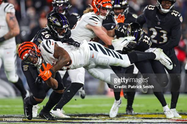 Joe Mixon of the Cincinnati Bengals is tackled by Geno Stone of the Baltimore Ravens during the first quarter at M&T Bank Stadium on November 16,...