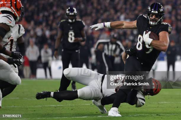 Mark Andrews of the Baltimore Ravens is tackled by Logan Wilson of the Cincinnati Bengals during the first quarter of the game at M&T Bank Stadium on...
