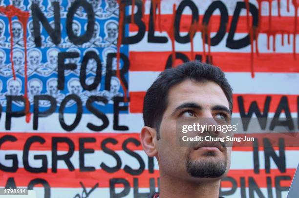 Muslim protester attends at an anti-war rally February 15, 2003 in Seoul, South Korea. More than 2,000 South Koreans rallied in Seoul joining a...