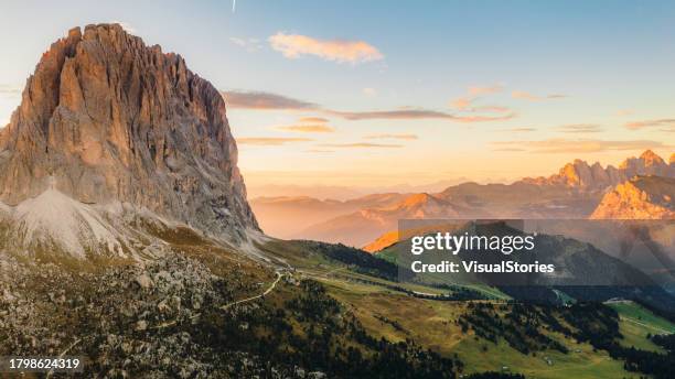 aerial view of paradise sunset over mountain layers and sella pass in dolomites alps - arrebol imagens e fotografias de stock