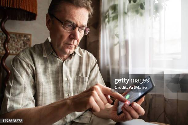 senior man refuses to answer to a call from unknown number. scam and fraud prevention with smartphone concept. - hoax stock pictures, royalty-free photos & images
