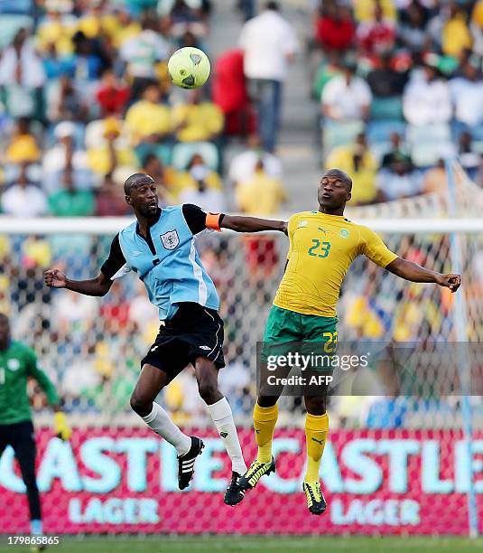Botswana's Mompati Thuma vies with South Africa's Tokelo Rantie during a 2014 FIFA World Cup Qualifying football match South Africa vs Botswana at...
