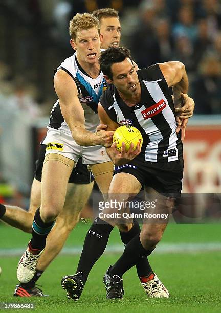 Alan Didak of the Magpies is tackled by Matthew Lobbe of the Power during the Second AFL Elimination Final match between the Collingwood Magpies and...