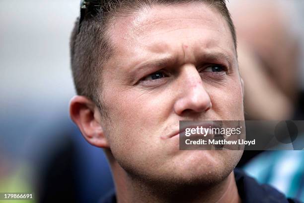 Stephen Lennon aka Tommy Robinson, leader of the English Defence League, pauses before a group march to Aldgate by EDL supporters on September 7,...