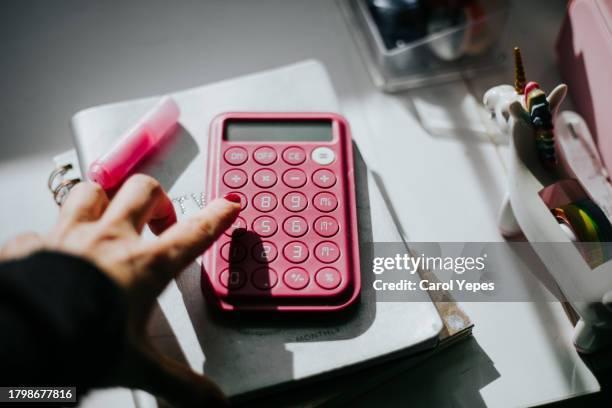 calculator and pencil and some clips in white.tax refund concept - erstattung stock-fotos und bilder