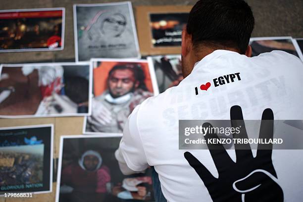 Supporter of ousted Egyptian president Mohamed Morsi, displays pictures of people killed during the last events in Egypt, during a demonstration of...