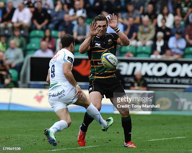 George North of Northampton Saints blocks a kick from Haydn Thomas of Exeter Chiefs during the Aviva Premiership match between Northampton Saints and...