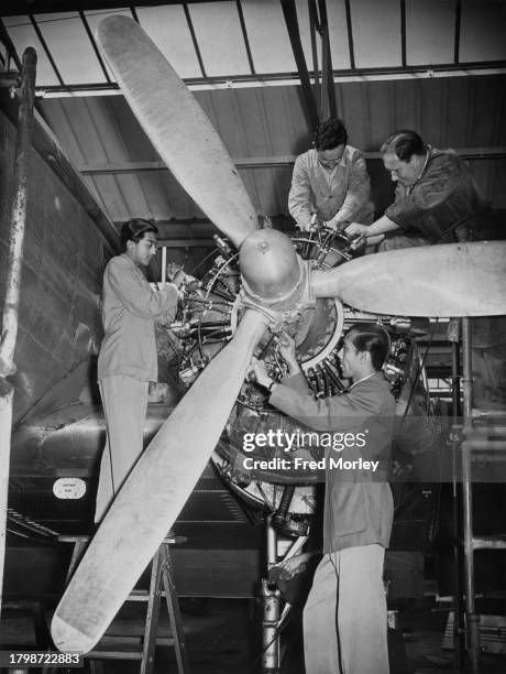 Pakistani student Afsar Hussain and Indian student AK Bhadra under the guidance of Air Service Training mechanics Mr Bowdler and Mr Hunter, work on...