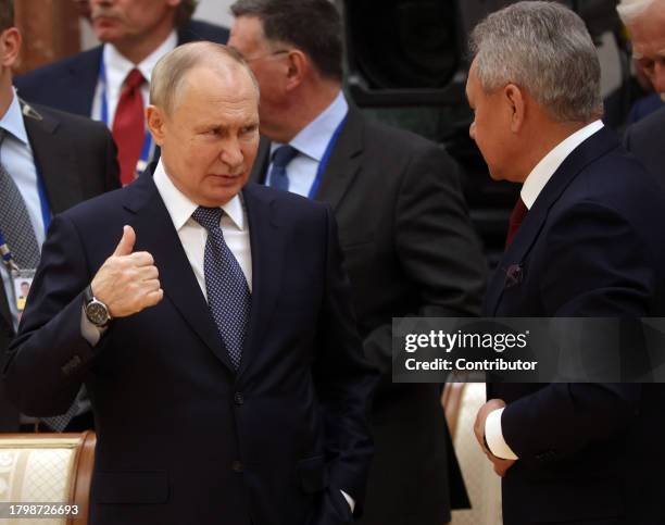 Russian President Vladimir Putin talks to Defence Minister Sergei Shoigu during the SCTO Summiton November 23 in Minsk, Belarus. Presidents of...