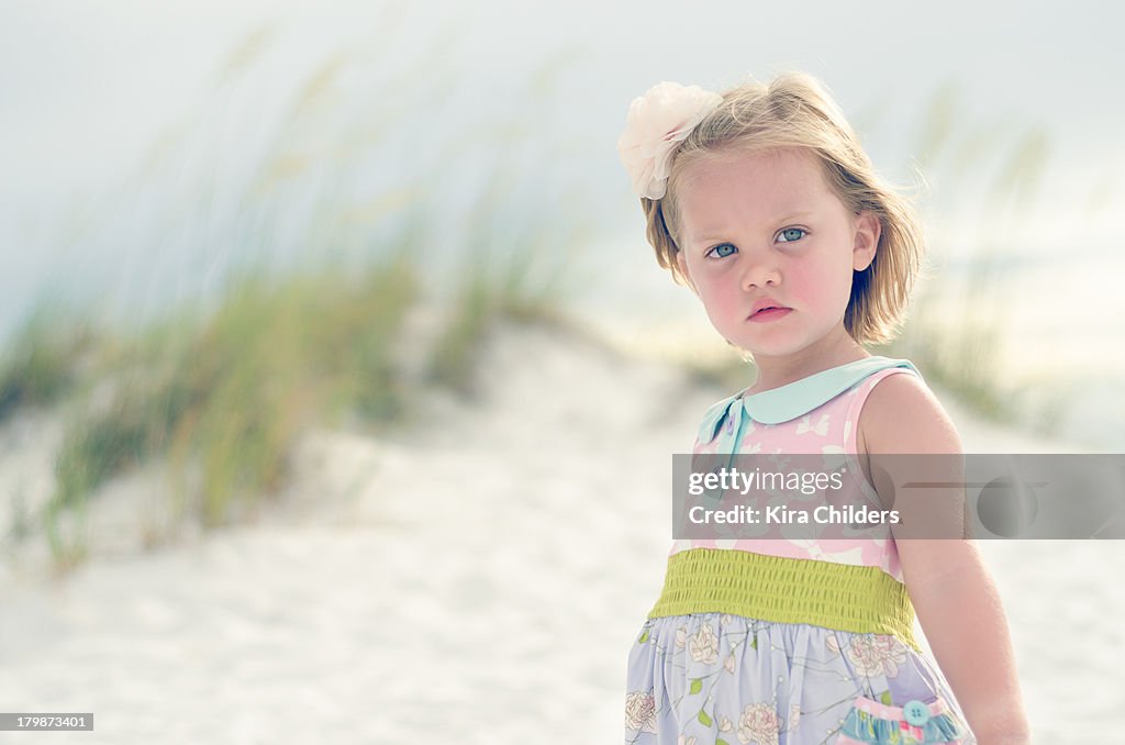 Pensive young girl near sand dunes