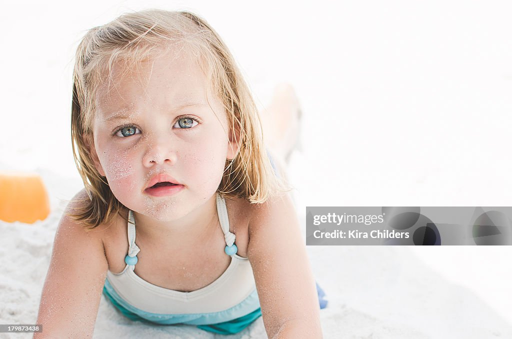 Toddler girl taking a break at the beach