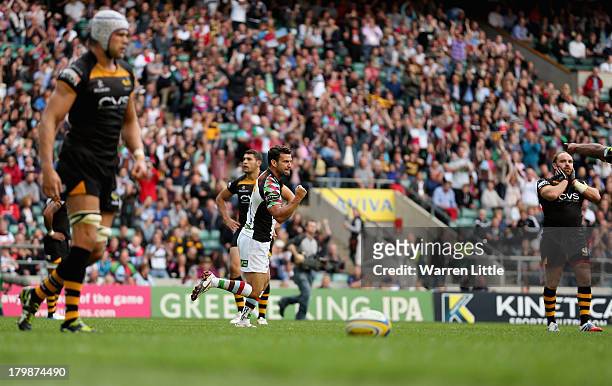 Karl Dickson of Harlequins is congratulated by team mate Jordan Turner-Hall after scoring a try during the Aviva Premiership match between London...