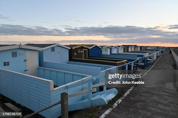 General view of beach huts on the beach at dusk on November 15, 2023 in Frinton-on-Sea, United Kingdom.