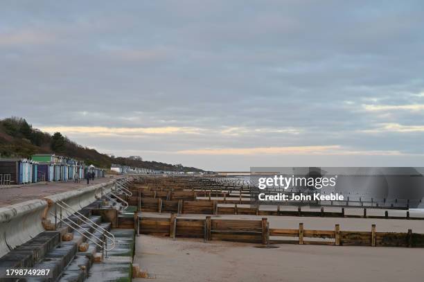 General view of beach huts on the promenade by the beach at dusk on November 15, 2023 in Frinton-on-Sea, United Kingdom.