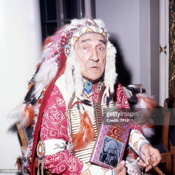 Portrait of Lakota Sioux actor Chief Red Fox as he poses with a copy of his book, 'The Memoirs of Chief Red Fox,' London, England, October 8, 1971.