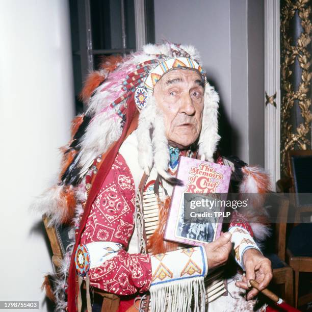 Portrait of Lakota Sioux actor Chief Red Fox as he poses with a copy of his book, 'The Memoirs of Chief Red Fox,' London, England, October 8, 1971.