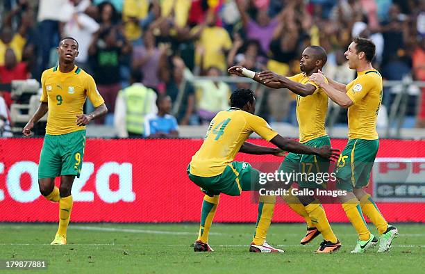 Bernard Parker of South Africa celebrates with team-mates after scoring a goal during the 2014 FIFA World Cup Qualifier match between South Africa...