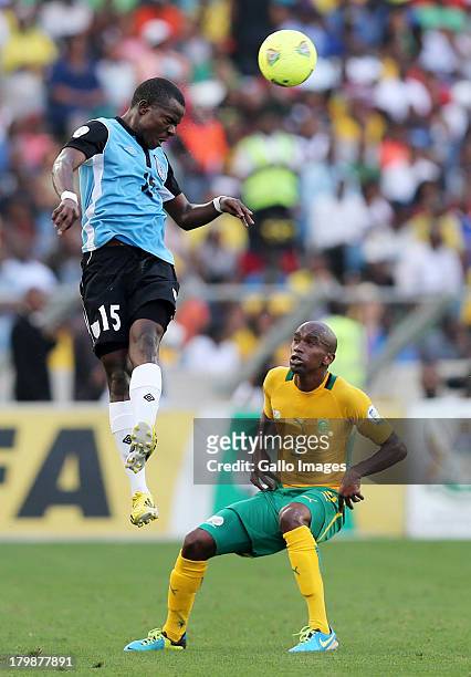 Galabgwe Moyana heads the ball away from Anele Ngcongca of South Africa during the 2014 FIFA World Cup Qualifier match between South Africa and...