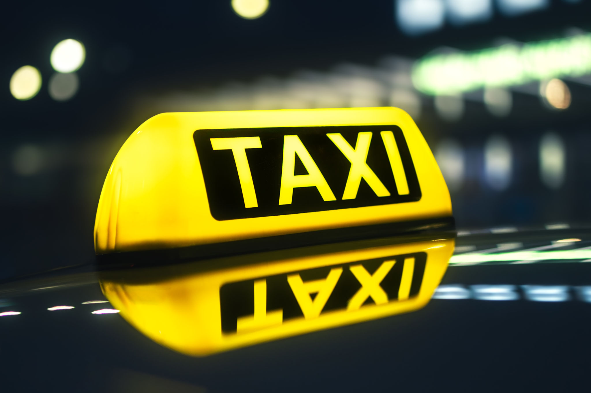 Close-up of taxi sign on car at night Close-up of taxi sign on car at night