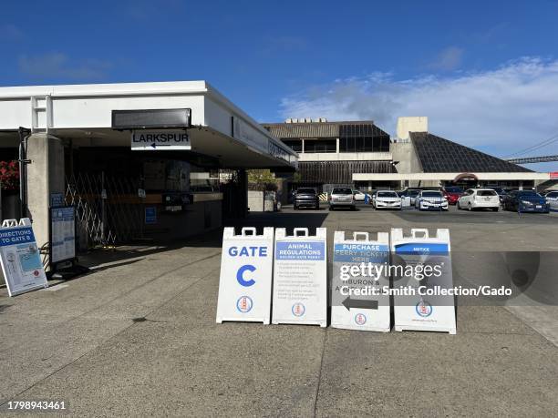 Exterior view of the Larkspur Golden Gate Ferry terminal with informational signs and the Bay Bridge in the background, San Francisco, California,...