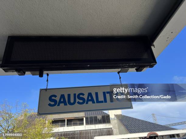 Hanging 'SAUSALITO' sign with a view of the Bay Bridge in the background, located at Harry Bridges Plaza, Port of San Francisco, San Francisco,...